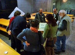 A group admiring Jacques Paquet's sketch box